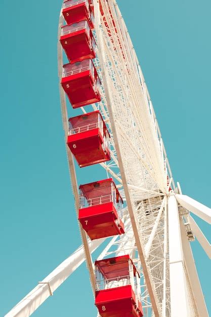 Premium Photo Low Angle View Of Ferris Wheel Against Clear Blue Sky