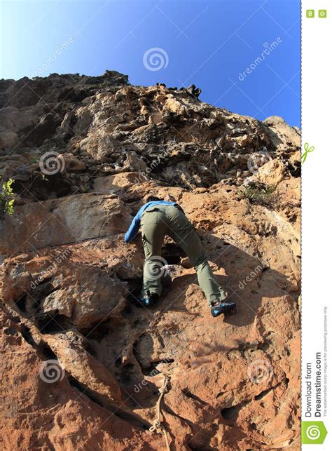 Woman Rock Climber Climbing At Seaside Mountain Cliff Stock Photo