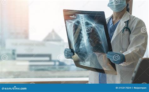 Doctor With Radiological Chest X Ray Film For Medical Diagnosis On