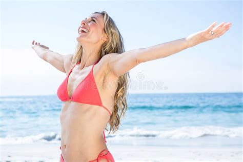 Fit Blonde In Red Bikini Presenting With Hand Stock Photo Image Of