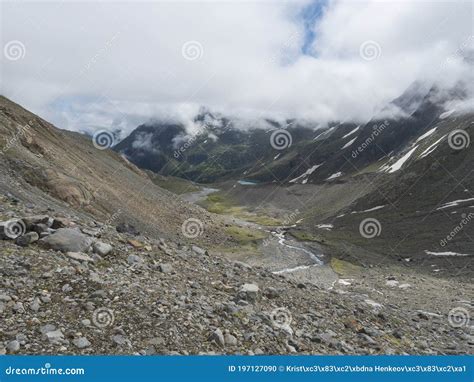 Summer View Of Alpine Mountain Valley With Winding Stream And Glacial