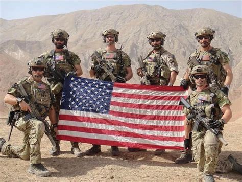 1st Sfodcag D Squad Posing For A Picture With An American Flag