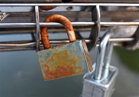 Premium Photo Close Up Of Padlock On Metal Fence