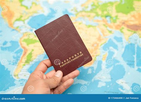 Man Holds With His Hand The Passport World Map Travel Concept Stock