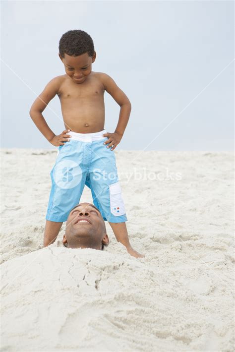 Father Buried In Sand At The Beach Royalty Free Stock Image Storyblocks