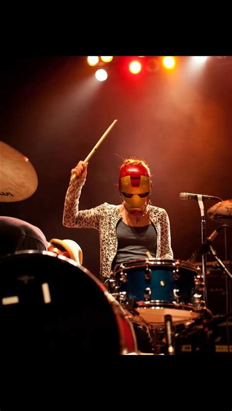 A Woman With Red Hair Playing Drums On Stage