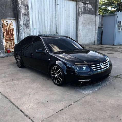 A Black Car Parked In Front Of A Building