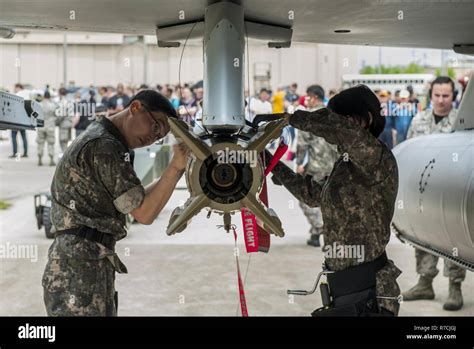 Republic Of Korea Air Force Airmen Secure A Bomb To An F 16 Fighting