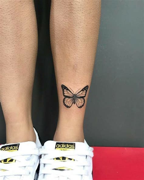 A Woman S Foot With A Butterfly Tattoo On Her Left Leg And The Word