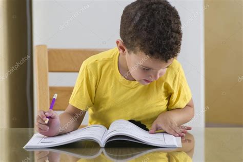 Young Schoolboy Studying Hard Stock Photo by ©MidoSemsem 64161895