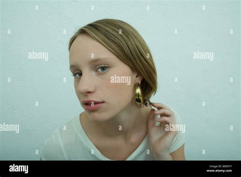 Teen Girl Wearing Large Hoop Earring Looking At Camera Stock Photo