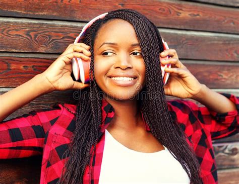 Portrait Of Happy Smiling African Woman Listening To Music In