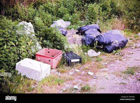 Illegal Dumping With Bottles Boxes And Plastic Bags Abandoned In