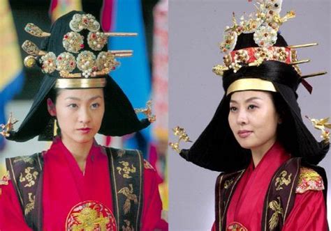 Two Women In Traditional Chinese Costumes And Hats