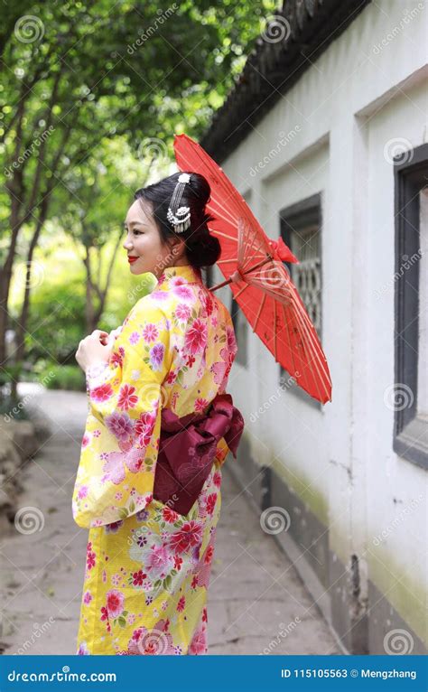 Traditional Asian Japanese Beautiful Bride Geisha Woman Wears Kimono Hold A White Red Umbrella