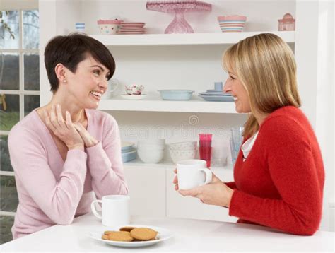 Two Women Enjoying Hot Drink In Kitchen Stock Image Image Of Kitchen Chatting
