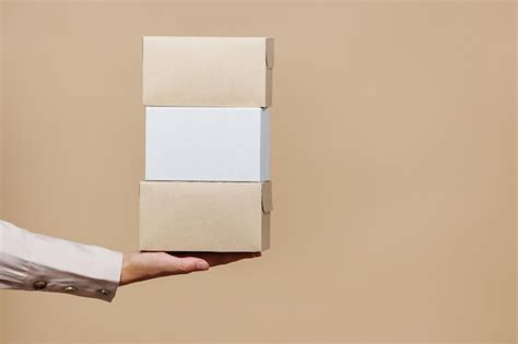 Premium Photo Woman39s Hand Holds Cardboard Boxes For Delivery Food