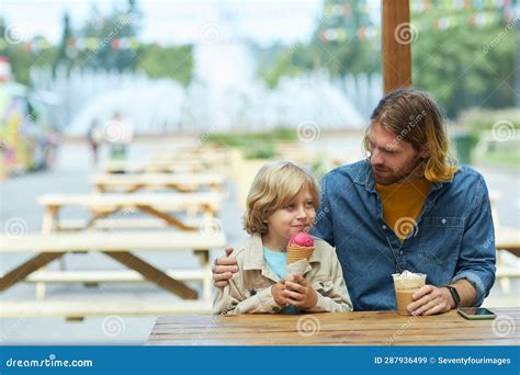 Father And Son Eating Ice Cream In Cafe Outdoors Stock Image Image Of