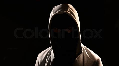 Mysterious man with hoodie on the black ... | Stock image | Colourbox