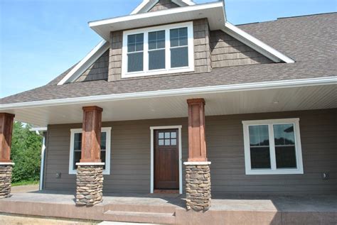 Exterior With Gray Siding Cedar And White Trim And Stone Accents