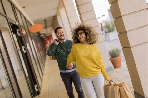 Beautiful Young Multiethnic Couple Enjoying In Shopping Having Fun In