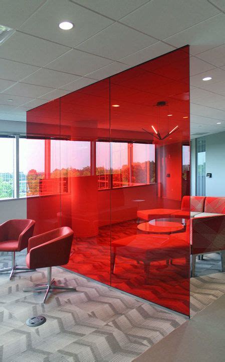 An Office With Red Glass Walls And Chairs