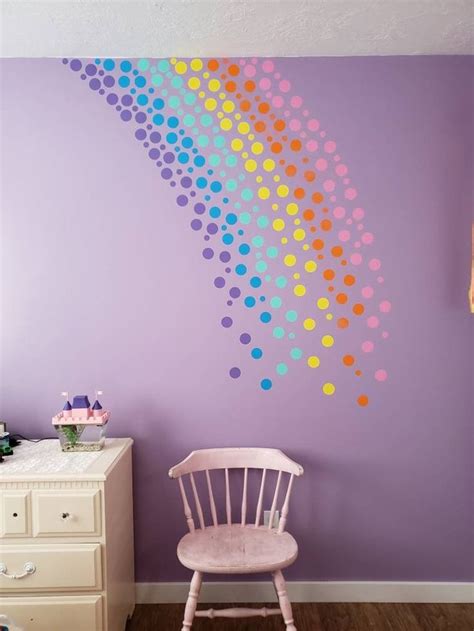 A Chair In Front Of A Purple Wall With Polka Dots On It And A Rainbow