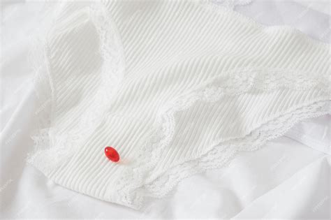 Premium Photo White Cotton Panties For Women And A Red Pill Concept