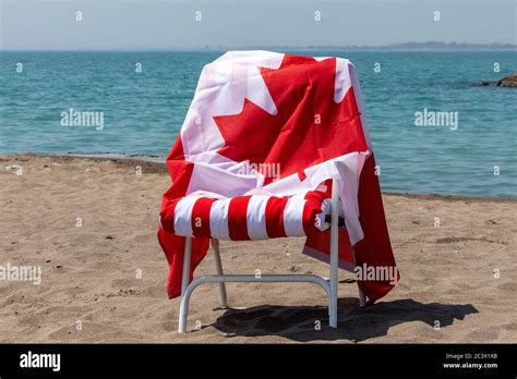 Canada Day Celebration On The Beach With A Canadian Flag Draped Over A