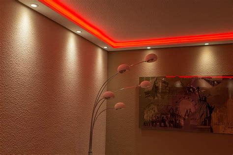 A Living Room With Pink Walls And Lights On The Ceiling Is Pictured In