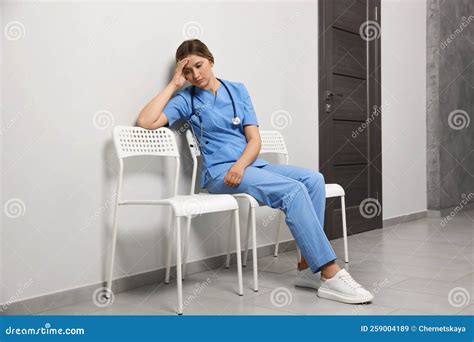 Exhausted Doctor Resting On Chair In Hospital Stock Image Image Of