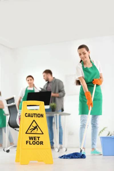 Low Section Male Janitor Cleaning Floor Caution Wet Floor Sign Stock