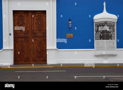 Imposing Wooden Door To Bright Blue And White Spanish Colonial Style