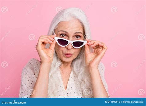 Close Up Portrait Of Attractive Amazed Grey Haired Woman Touching Specs