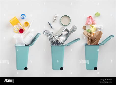 Trash Bins And Assorted Garbage On Grey Background Recycle Concept