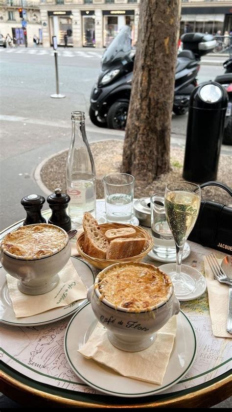 A Table Topped With Plates And Bowls Filled With Food Next To A Glass