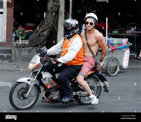 Caucasian Tourist On The Back Of A Motorcycle Taxi Bangkok THailand