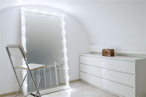 Premium Photo | A white mirror with a white frame and a white shelf ...