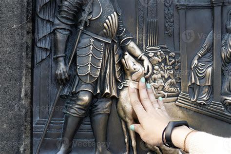 hands touching dog statue on charles bridge prague 17408298 Stock Photo