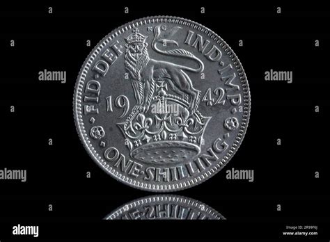 Reverse Of A Uk 1942 One Shilling Coin Featuring A Lion Stood On The
