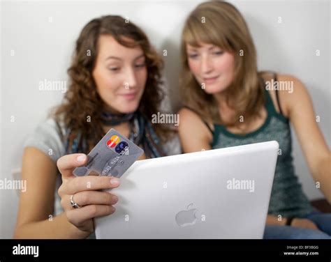 Friends shopping online together Stock Photo - Alamy
