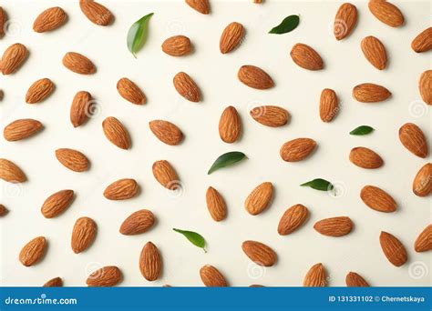 Composition With Organic Almond Nuts On Light Background Stock Photo