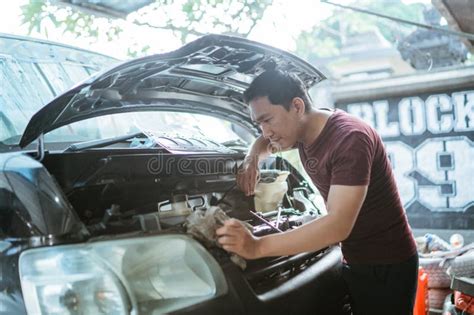 A Mechanic Opens the Hood To Repair a Car Engine Stock Image - Image of people, indoors: 303689083