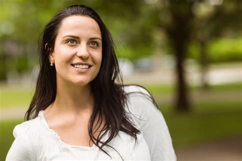 Premium Photo Portrait Of A Smiling Brunette Standing