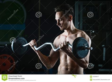 Strong Muscular Man Working Out In Gym Doing Exercises With Barbell At Biceps Stock Image