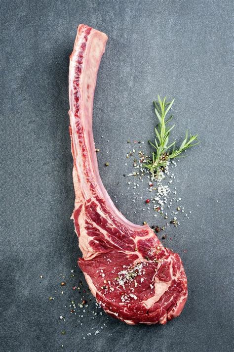 Raw Wagyu Tomahawk Beef Steak With Salt And Pepper On A Gray Design