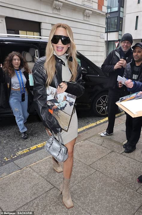 Rita Ora Puts On A Leggy Display In Grey Mini Dress As She Arrives At