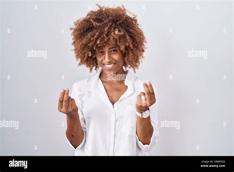 Young Hispanic Woman With Curly Hair Standing Over White Background