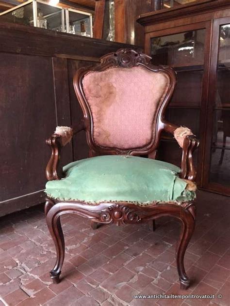 An Old Wooden Chair With A Green Cushion