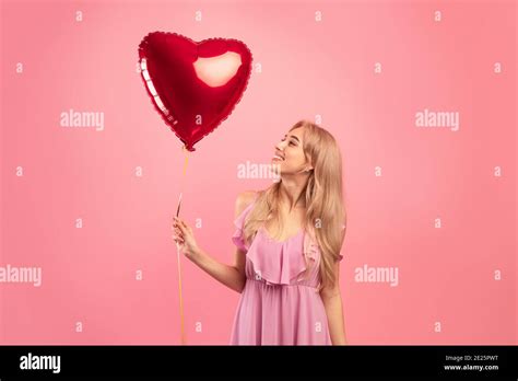 Symbol Of Love Beautiful Blonde Woman With Heart Shaped Air Balloon On Pink Studio Background